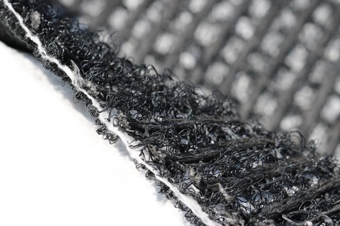 Synthetic monofilaments bonded to filtering geotextile and reinforced geomat